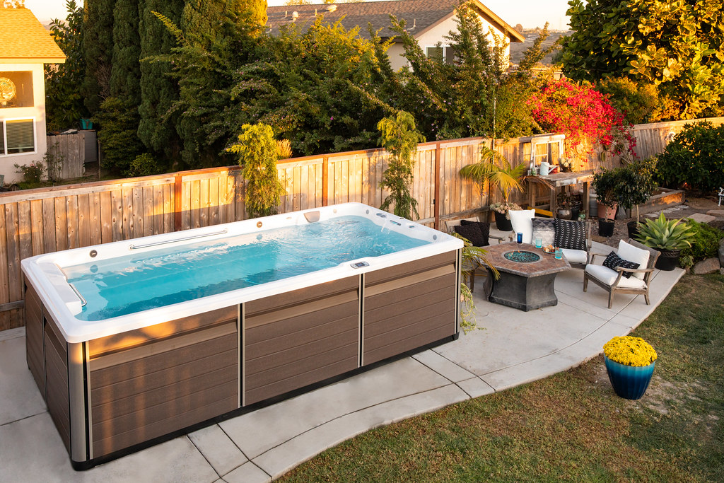 An Endless Pools swim spa set into a landscaped backyard